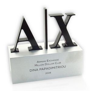 Acrylic desk award with large letter cutout branding.