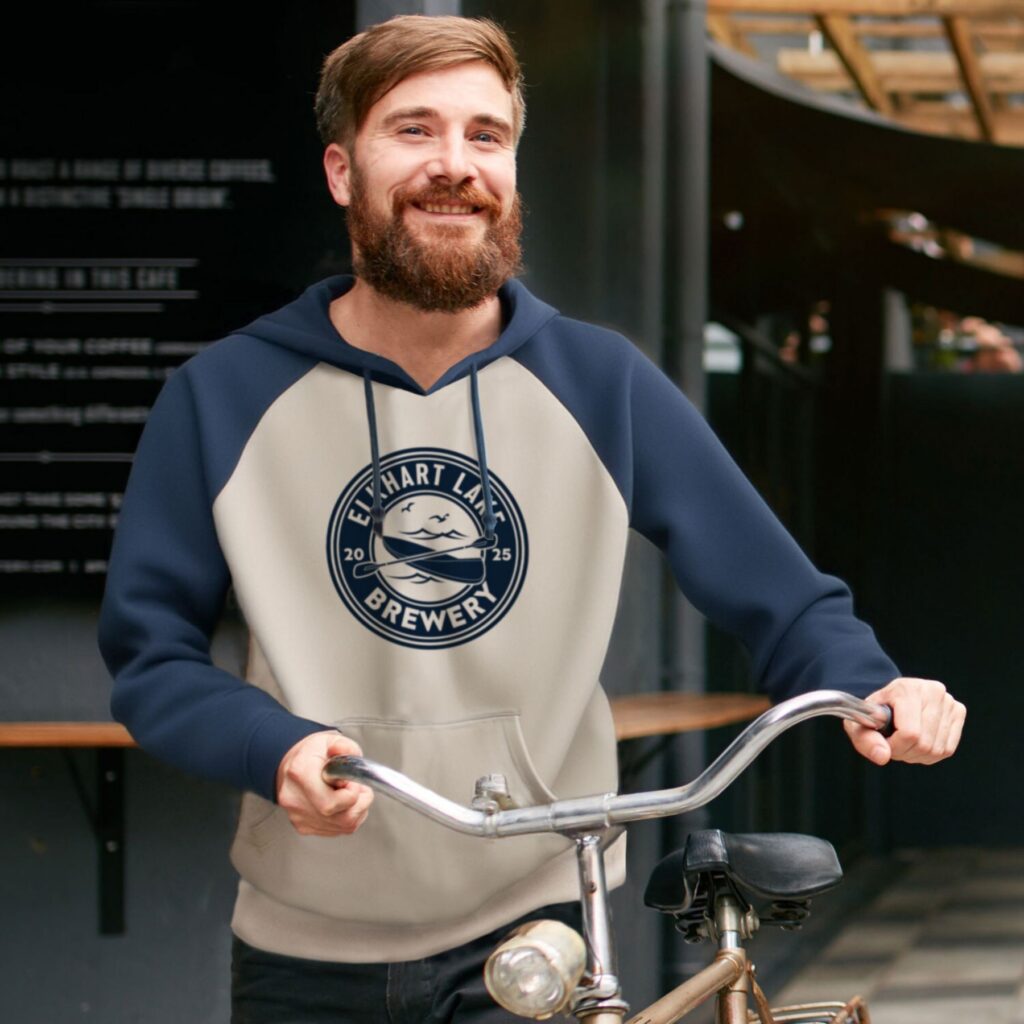 Promotional apparel shown on a person holding a scooter outdoors.