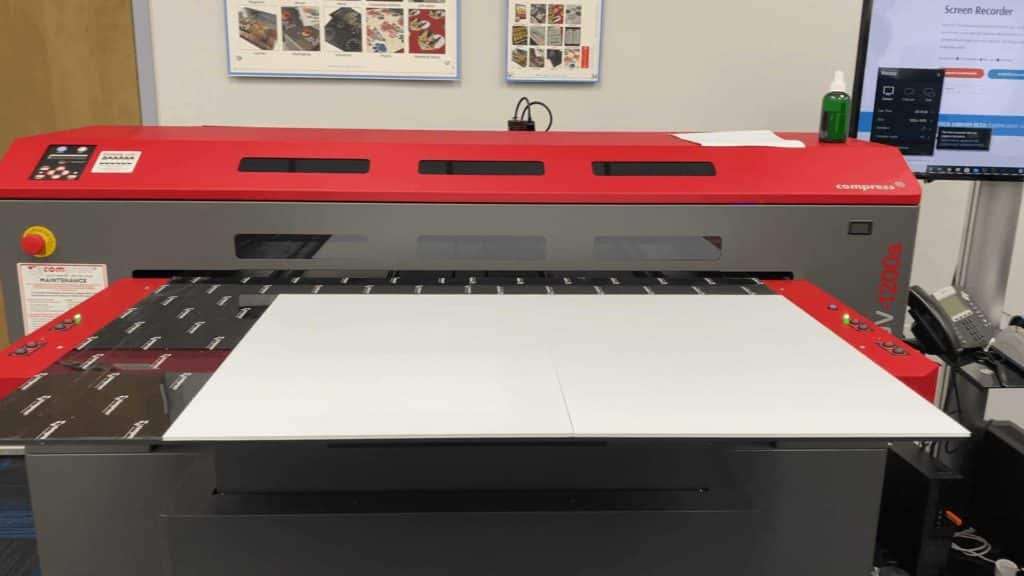 Flatbed printer producing coroplast sign panels in a print shop