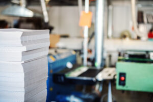 printing machine and large stack of brochures