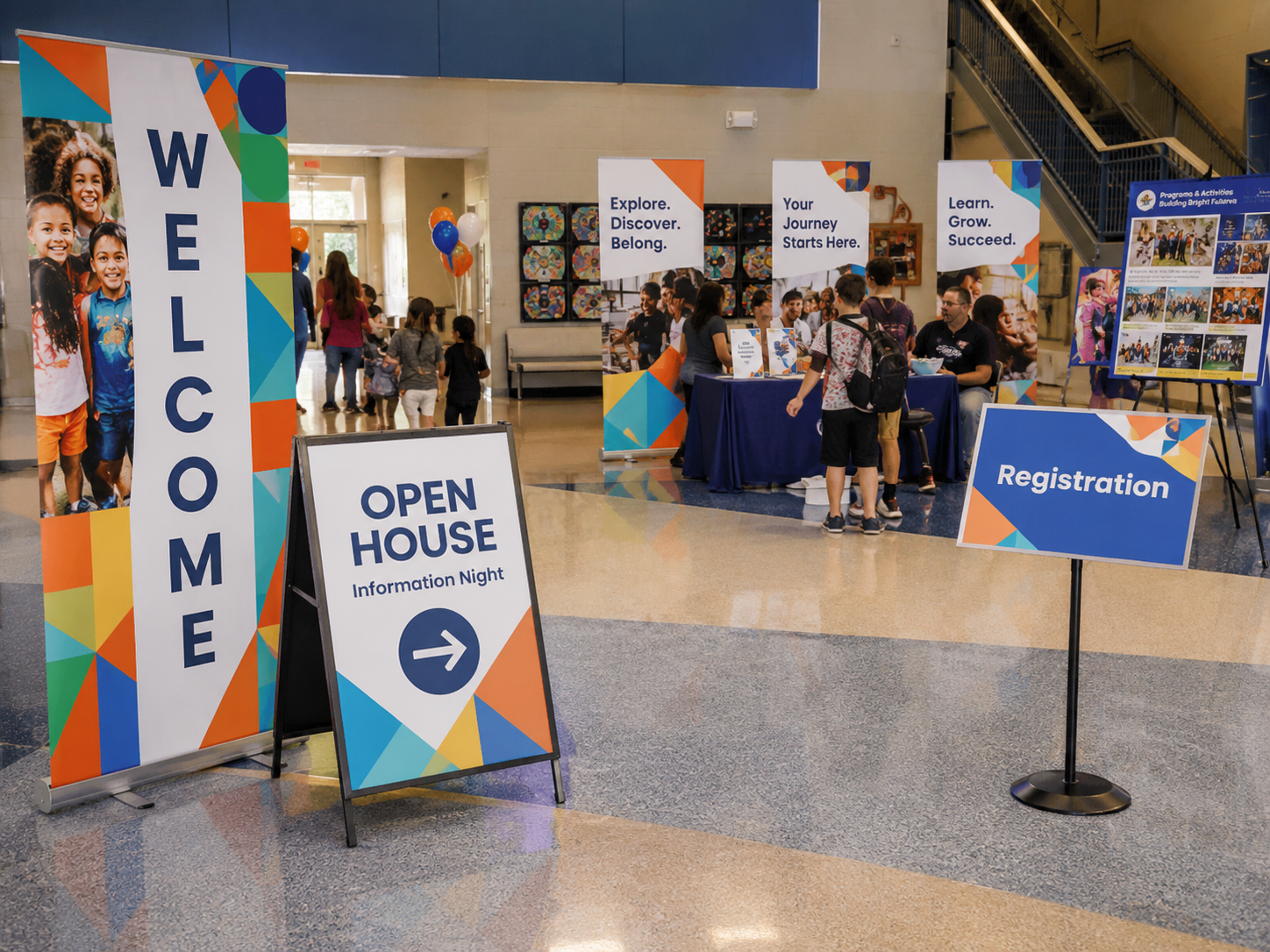 Banners, welcome signs, registration displays, and presentation boards at a school open house